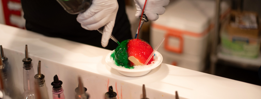 person pouring colored syrups over a ball of ice - Anytime Bar Supplies Pour Spouts