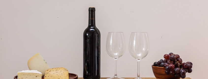 open bottle of wine with glasses on a shelf - Pour Spouts by Anytime Bar Supplies
