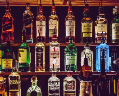 shelves of alcohol bottles - Pour Spouts by Anytime Bar Supplies Measure Accurate Liquor Pours