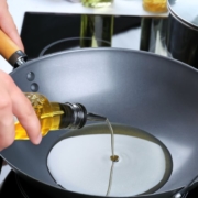 person pouring olive oil into a pan - Pour Spouts by Anytime Bar Supplies stainless steel pour spouts for olive oil