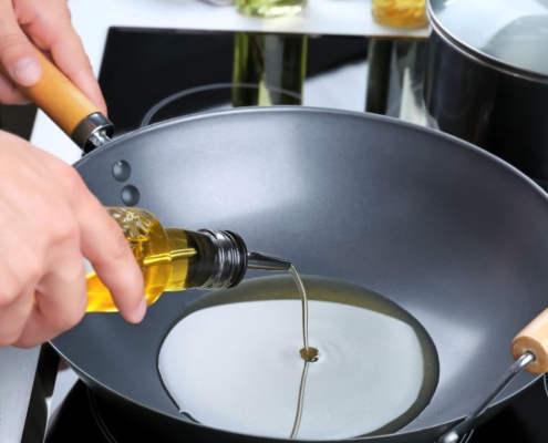 person pouring olive oil into a pan - Pour Spouts by Anytime Bar Supplies stainless steel pour spouts for olive oil