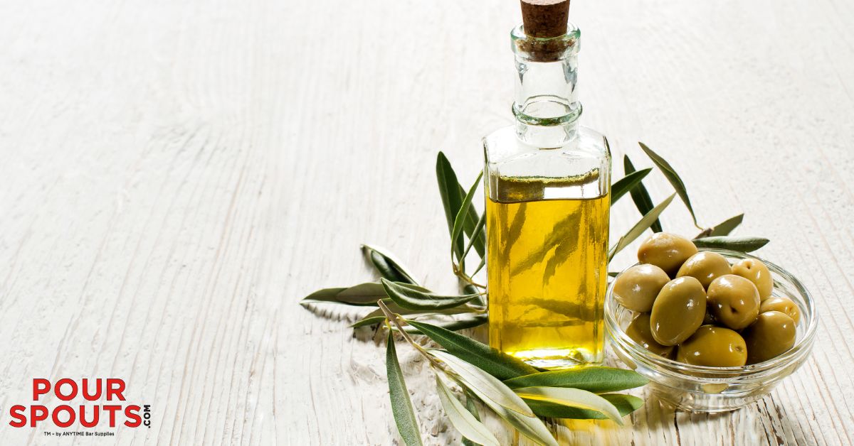 clear bottle of green olive oil - Pour Spouts by Anytime Bar Supplies Mediterranean Herb Vinaigrette Recipe