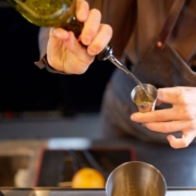 PourSpoutsbyAnytimeBarSupplies-stainless-steel-pour-spout-for-alcohol-041120251 person pouring alcohol into a glass - Pour Spouts by Anytime Bar Supplies Measure Accurate Liquor Pours