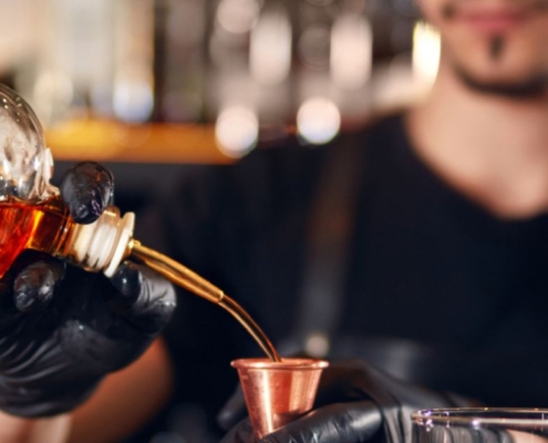 person pouring alcohol into a glass - Pour Spouts by Anytime Bar Supplies pour spout