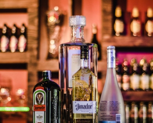 bottles of alcohol on a bar top - Pour Spouts