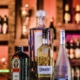bottles of alcohol on a bar top - Pour Spouts