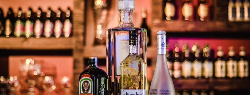 bottles of alcohol on a bar top - Pour Spouts
