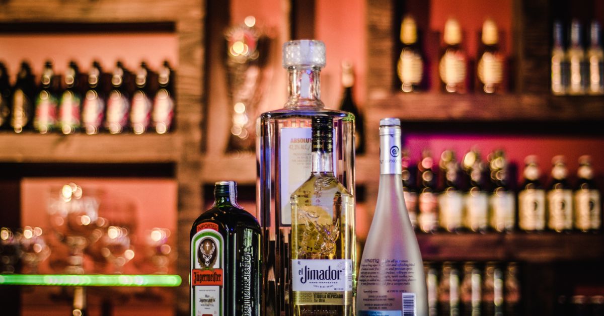 bottles of alcohol on a bar top - Pour Spouts