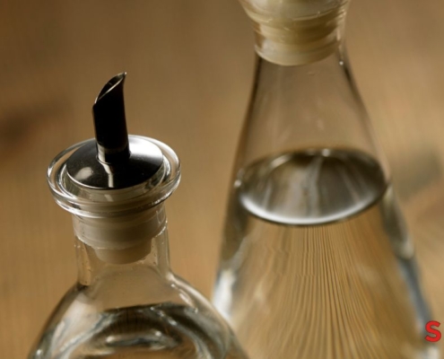 two clear bottles of vinegar - Pour Spouts by Anytime Bar Supplies stainless-steel pour spout for vinegar