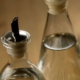 two clear bottles of vinegar - Pour Spouts by Anytime Bar Supplies stainless-steel pour spout for vinegar