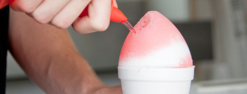 person pouring syrup over a snow cone - Pour Spouts
