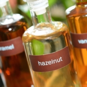 clear glass bottles containing coffee syrups - Pour Spouts for coffee syrups