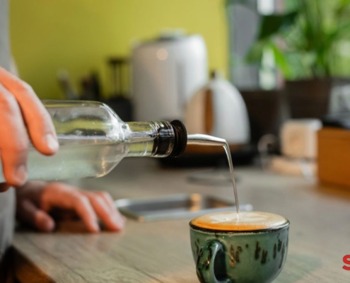 person pouring clear syrup into their coffee mug - Pour Spouts