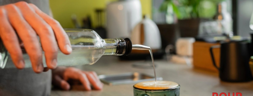 person pouring clear syrup into their coffee mug - Pour Spouts