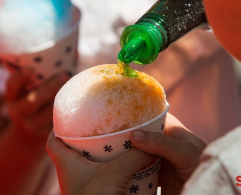 green syrup being poured over a snow cone - Pour Spouts