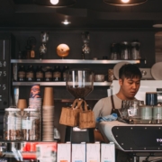 two individuals working at a coffee shop - Pour Spouts