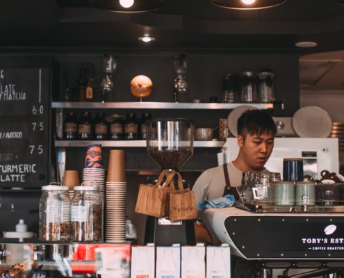 two individuals working at a coffee shop - Pour Spouts