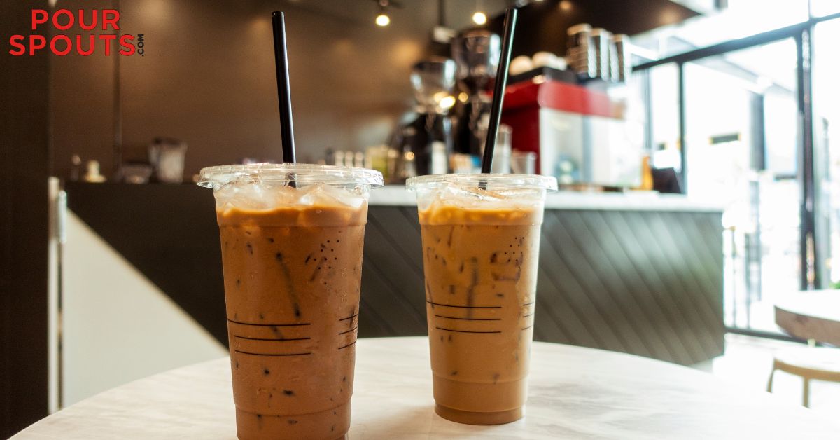 two iced coffee lates on a coffee shop counter - Pour Spouts