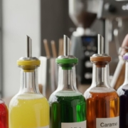 lineup of different syrups with labeled spouts - Pour Spouts