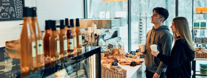 man and woman placing order at a coffee shop - Pour Spouts