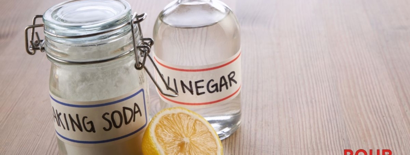 clear container of vinegar and baking soda - Pour Spout