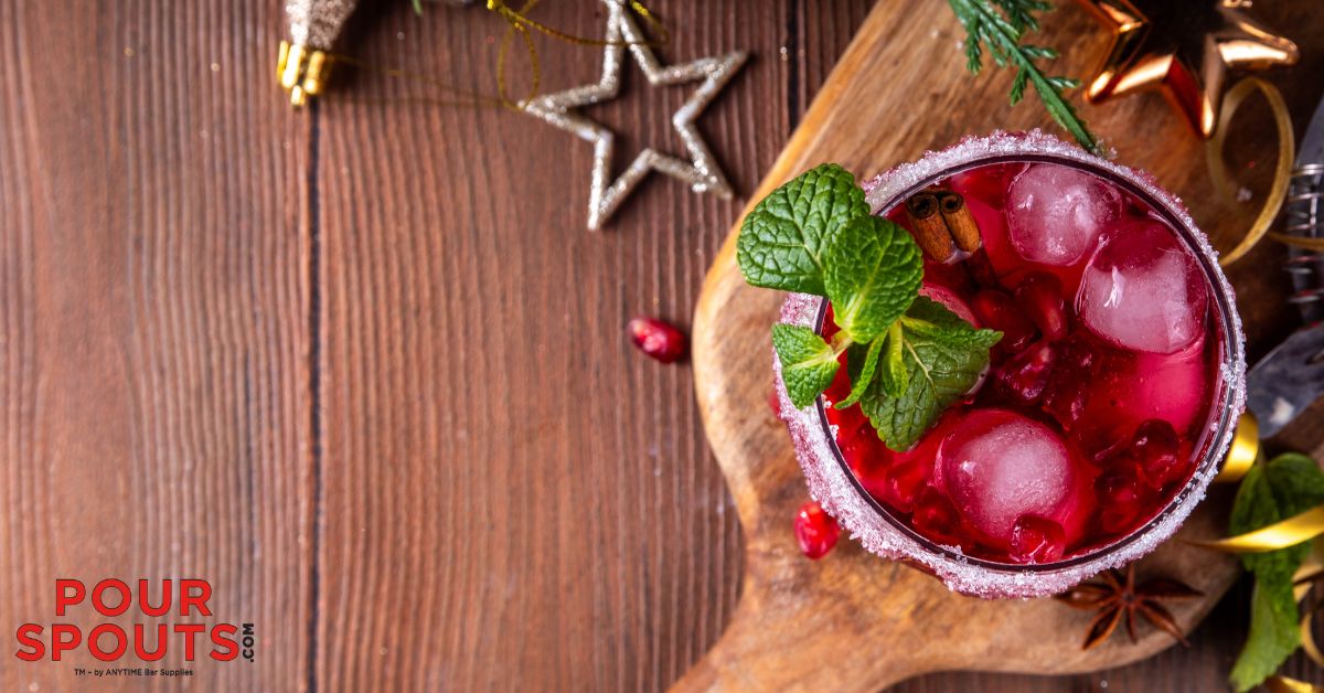 dark red mocktail on a wood board - Pour Spouts