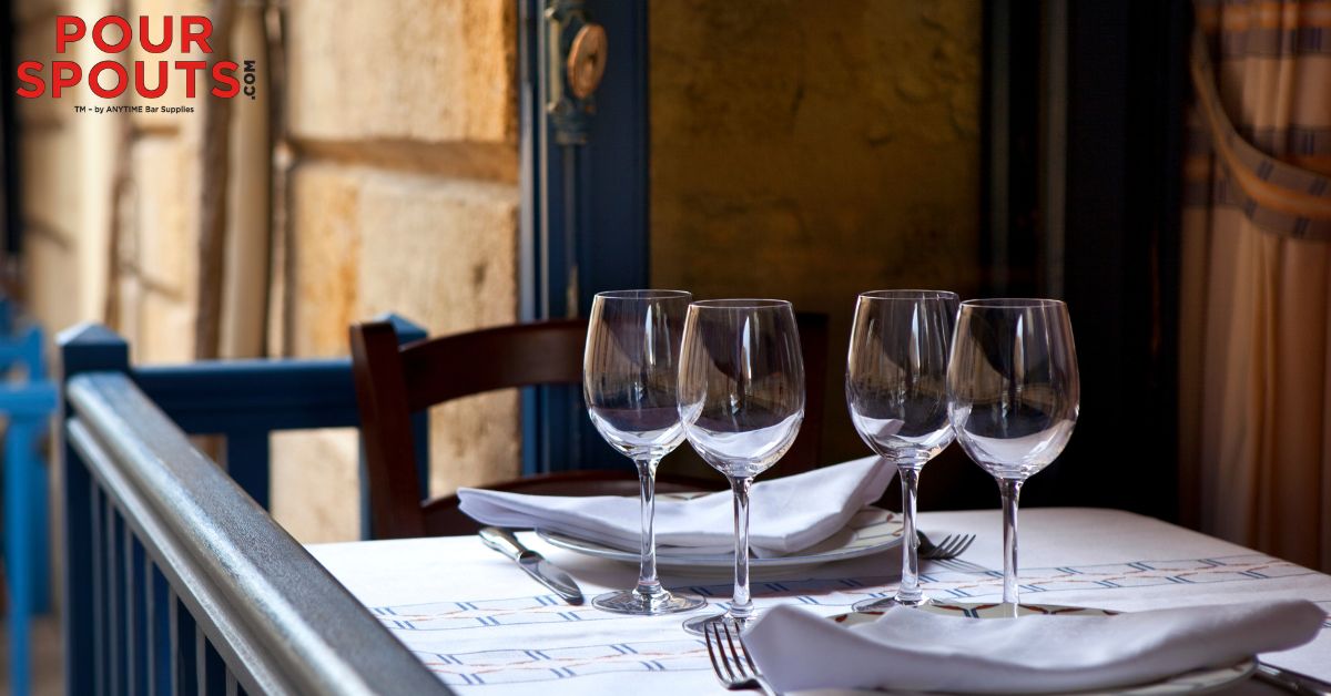 empty wine glasses at a bistro - Pour Spouts