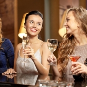 PourSpouts-cocktail-bar-021120262 women celebrating with alcoholic drinks - Pour Spouts cocktail bar