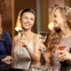 women celebrating with alcoholic drinks - Pour Spouts cocktail bar