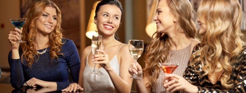 women celebrating with alcoholic drinks - Pour Spouts cocktail bar